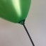 Green Balloon Tied to a Black Balloon Stick
