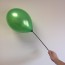 Hand Holding a Green Balloon on a Balloon Stick