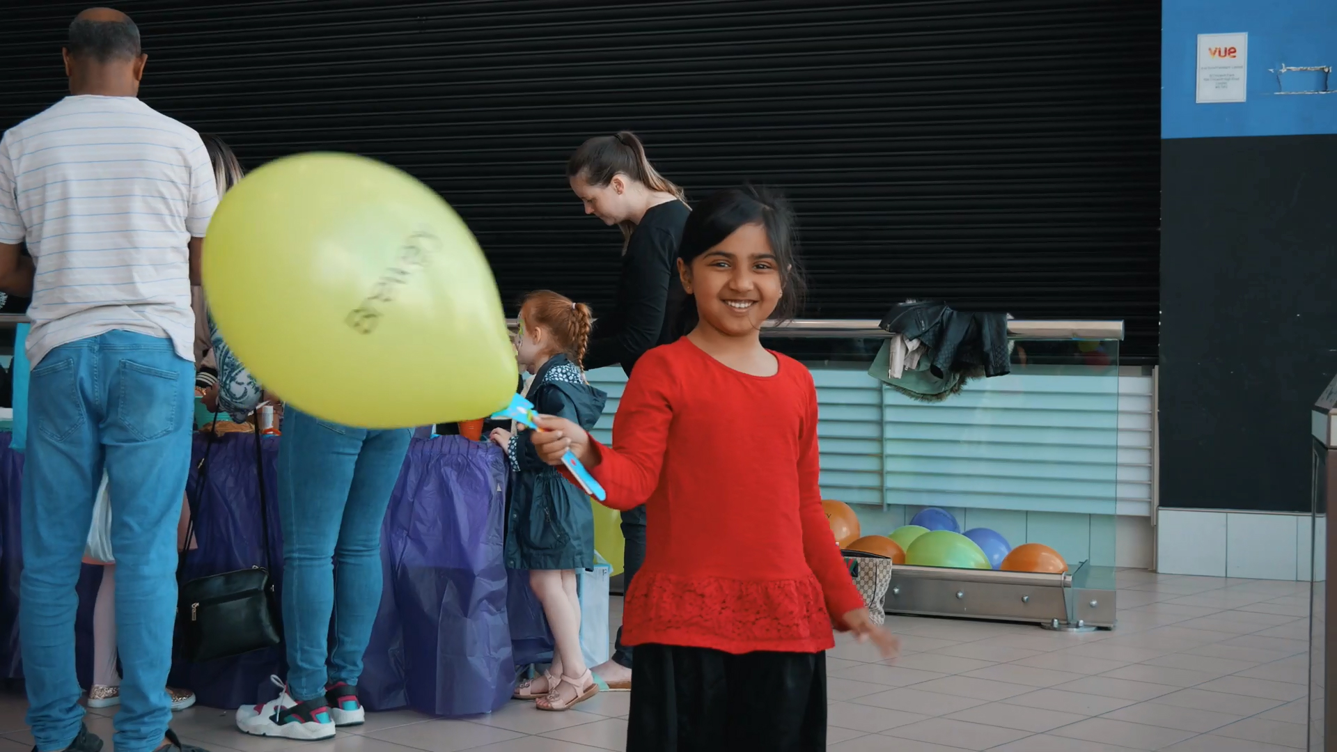 Girl Waving a Balloon on a BalloonGrip®